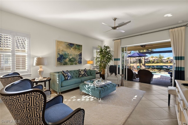 living room featuring light tile patterned flooring and ceiling fan