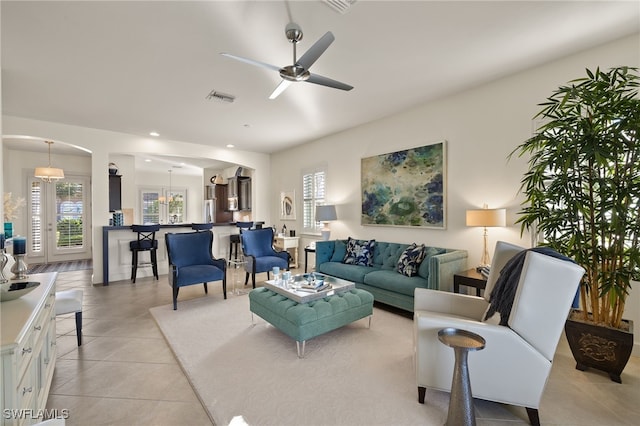 living room featuring light tile patterned floors and ceiling fan