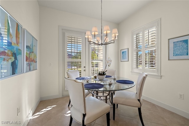 tiled dining space featuring a chandelier