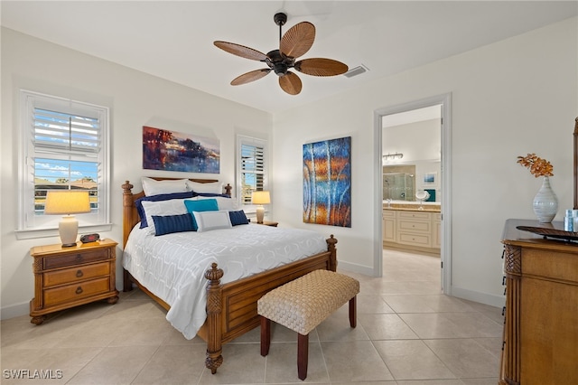 bedroom featuring light tile patterned flooring, ceiling fan, and ensuite bath