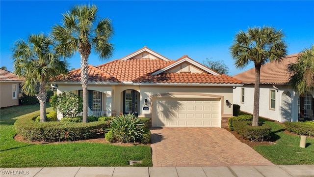 mediterranean / spanish-style house with a garage and a front yard