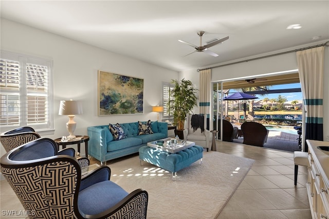 tiled living room with ceiling fan