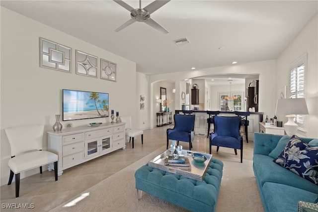 living room featuring light tile patterned floors and ceiling fan