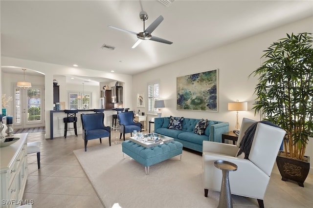 living room featuring light tile patterned floors and ceiling fan