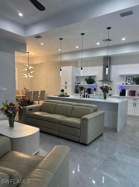 living room featuring sink and ceiling fan