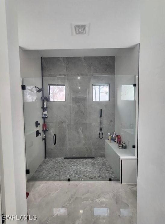 bathroom featuring tiled shower