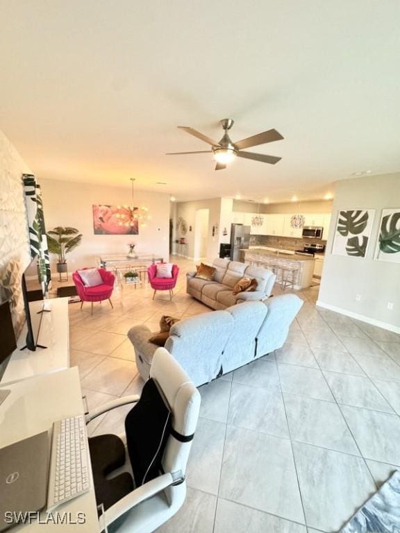 living room featuring light tile patterned floors and ceiling fan