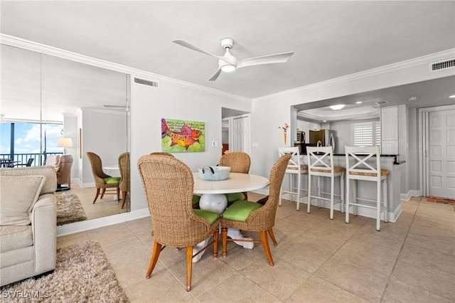 dining room with ornamental molding, light tile patterned flooring, and ceiling fan