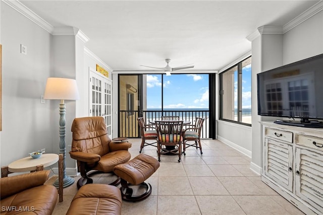 living room featuring light tile patterned flooring, ceiling fan, and ornamental molding