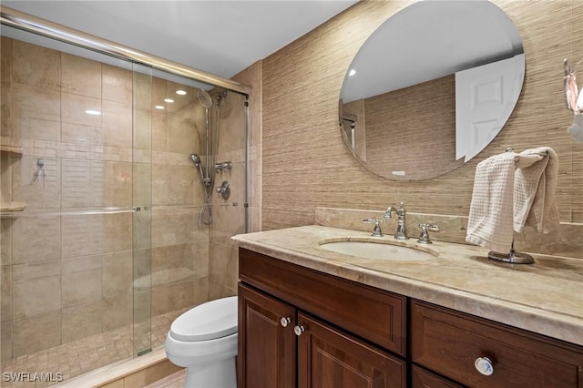 bathroom with vanity, a shower with shower door, decorative backsplash, and toilet