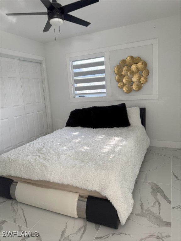 bedroom featuring ceiling fan and a closet