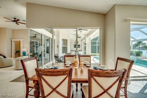 tiled dining area with ceiling fan