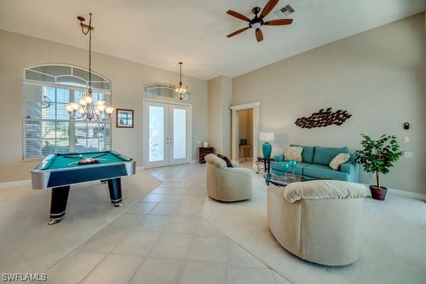 recreation room with plenty of natural light, french doors, ceiling fan, and light tile patterned flooring