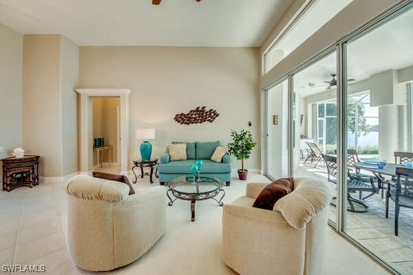 living room with light tile patterned floors and ceiling fan