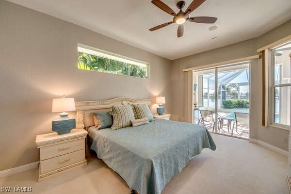 carpeted bedroom featuring multiple windows, access to outside, and ceiling fan