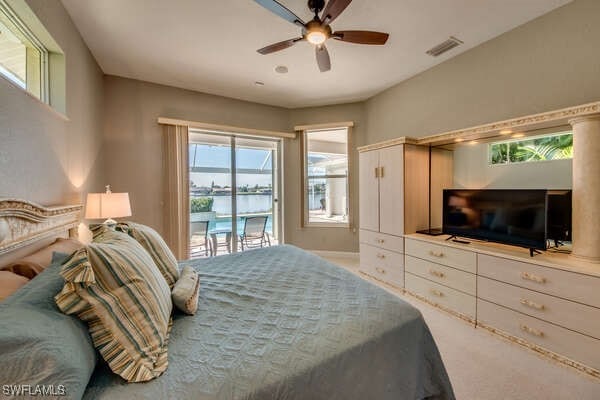 carpeted bedroom with access to exterior and ceiling fan