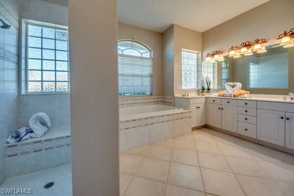 bathroom featuring vanity, separate shower and tub, and tile patterned flooring