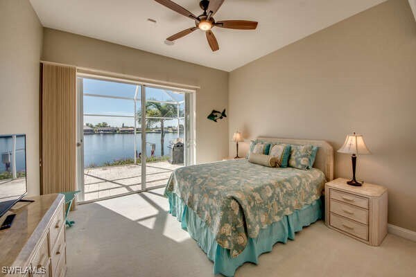 carpeted bedroom with a water view, ceiling fan, lofted ceiling, and access to exterior