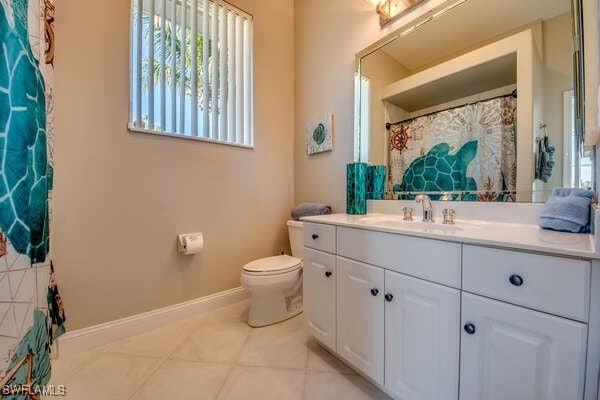 bathroom featuring tile patterned floors, toilet, and vanity