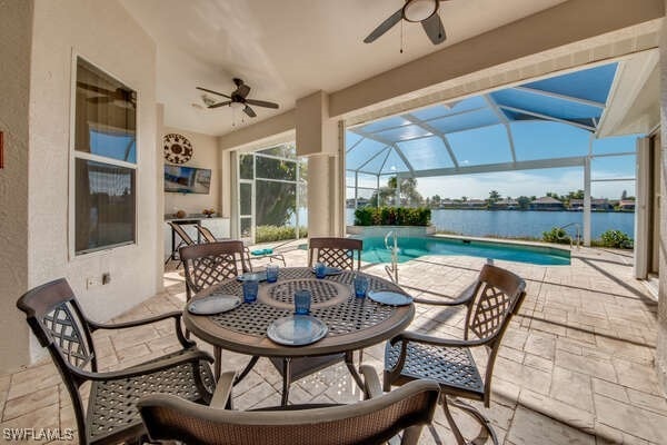 view of patio featuring ceiling fan, a fenced in pool, and glass enclosure