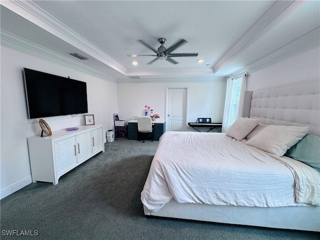 bedroom with ceiling fan, ornamental molding, a raised ceiling, and dark colored carpet