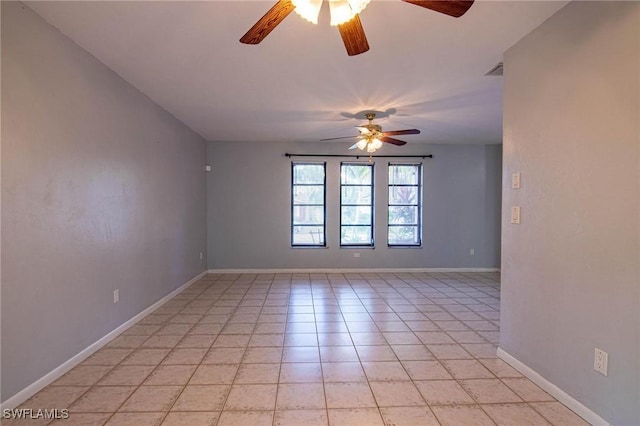 tiled spare room featuring ceiling fan