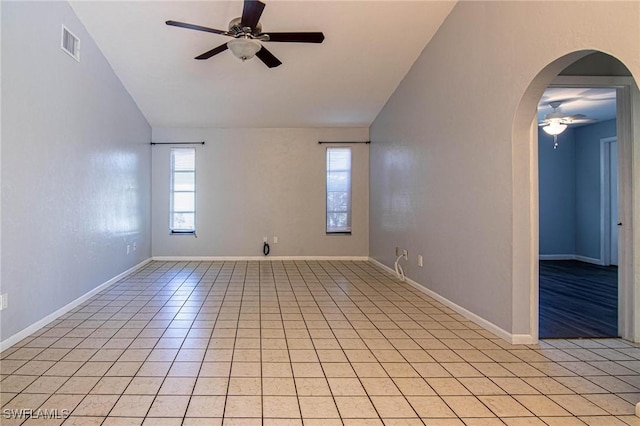 unfurnished room featuring lofted ceiling, light tile patterned floors, and ceiling fan