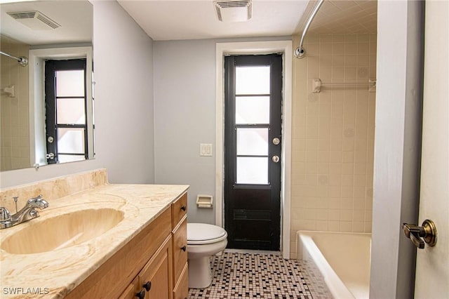 full bathroom with vanity, plenty of natural light, and toilet