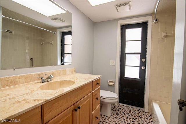 bathroom featuring vanity, plenty of natural light, and toilet