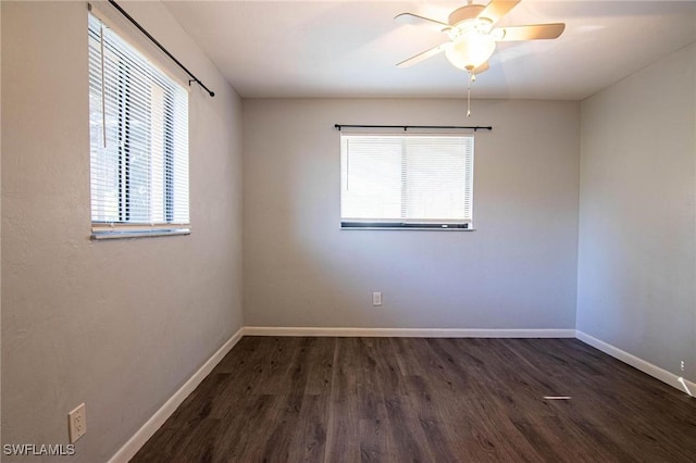 spare room with dark wood-type flooring and ceiling fan