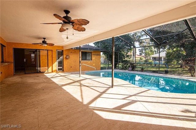 view of swimming pool with a lanai and a patio