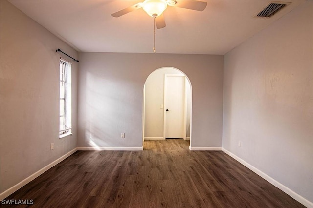 spare room with ceiling fan and dark hardwood / wood-style flooring