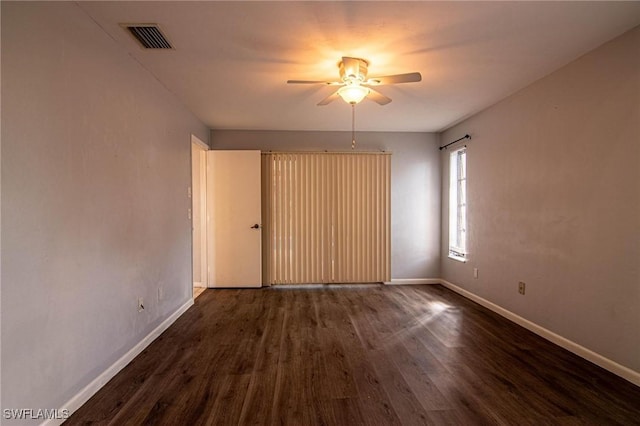 unfurnished room featuring dark hardwood / wood-style flooring and ceiling fan