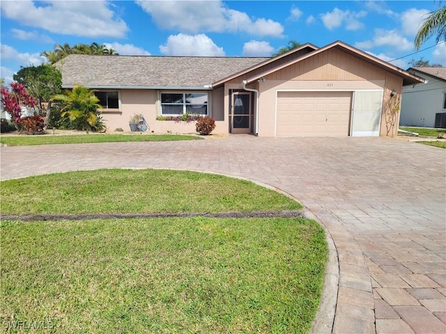 401 SE 8th Ter, Cape Coral, FL 33990 - ranch-style home with curved driveway, an attached garage, a front lawn, central AC, and a shingled roof