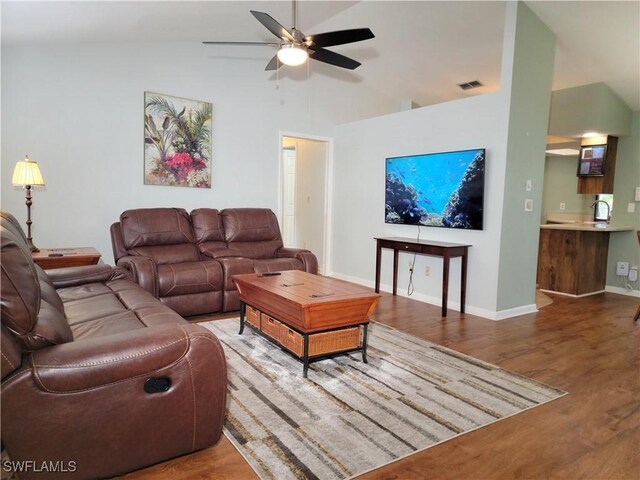 401 SE 8th Ter, Cape Coral, FL 33990 - living room featuring a ceiling fan, wood finished floors, baseboards, and high vaulted ceiling