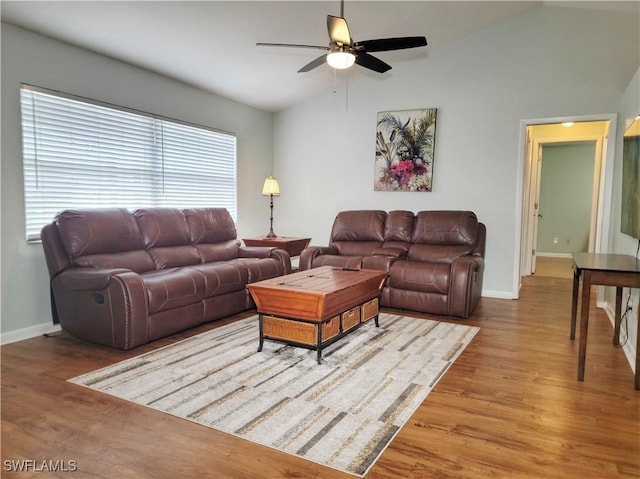 401 SE 8th Ter, Cape Coral, FL 33990 - living room featuring vaulted ceiling, a ceiling fan, wood finished floors, and baseboards