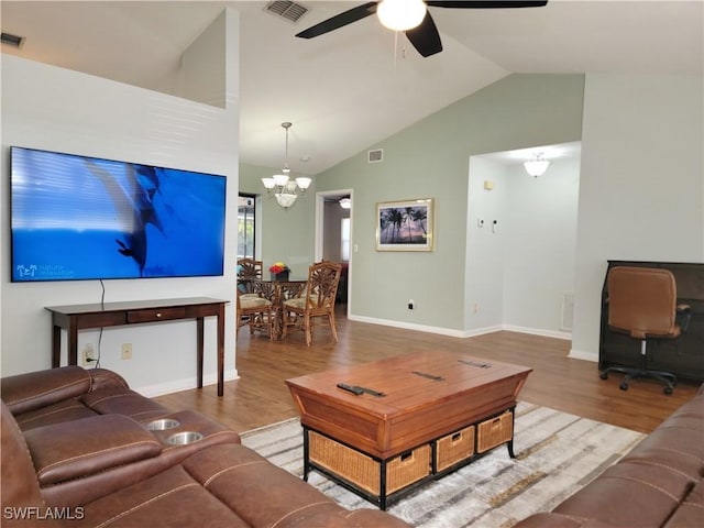 401 SE 8th Ter, Cape Coral, FL 33990 - living room featuring a chandelier, vaulted ceiling, wood finished floors, a ceiling fan, and baseboards