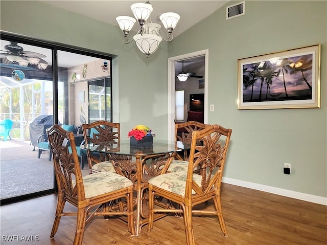401 SE 8th Ter, Cape Coral, FL 33990 - dining room featuring a chandelier, a ceiling fan, baseboards, vaulted ceiling, and wood finished floors