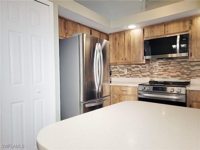 401 SE 8th Ter, Cape Coral, FL 33990 - kitchen featuring stainless steel appliances, light countertops, and backsplash