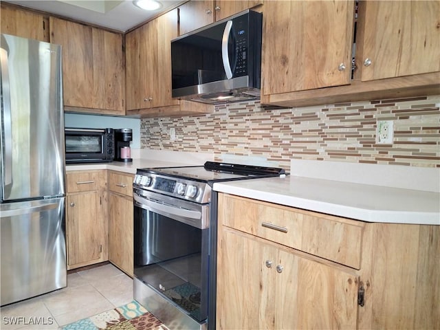 401 SE 8th Ter, Cape Coral, FL 33990 - kitchen featuring stainless steel appliances, light tile patterned floors, light countertops, and tasteful backsplash