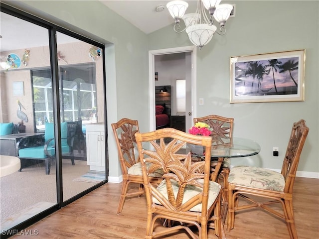 401 SE 8th Ter, Cape Coral, FL 33990 - dining room featuring light wood-style floors, a chandelier, baseboards, and lofted ceiling