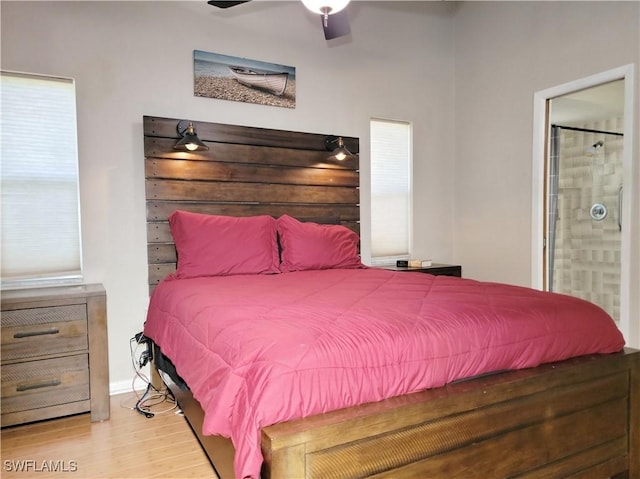 401 SE 8th Ter, Cape Coral, FL 33990 - bedroom with wood finished floors, ensuite bathroom, baseboards, and ceiling fan
