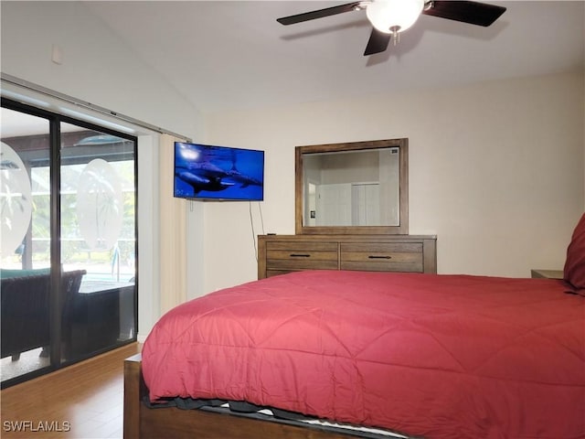 401 SE 8th Ter, Cape Coral, FL 33990 - bedroom featuring access to outside, lofted ceiling, wood finished floors, and ceiling fan