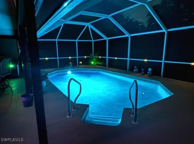 401 SE 8th Ter, Cape Coral, FL 33990 - pool at twilight featuring an outdoor pool, glass enclosure, and a patio area