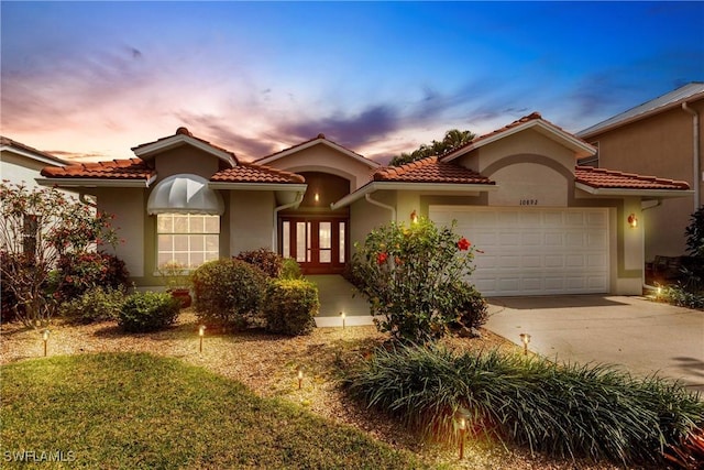 mediterranean / spanish-style home featuring a garage