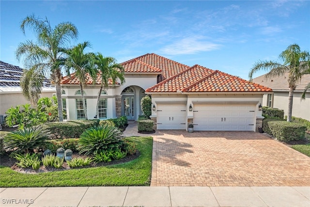 mediterranean / spanish house with a garage