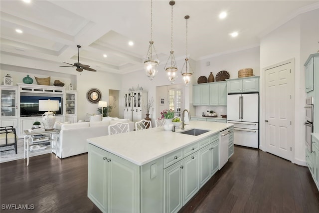 kitchen featuring coffered ceiling, sink, a center island with sink, dishwasher, and white fridge