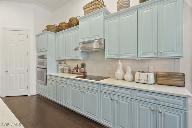 kitchen with dark wood-type flooring, ornamental molding, double oven, black electric stovetop, and backsplash