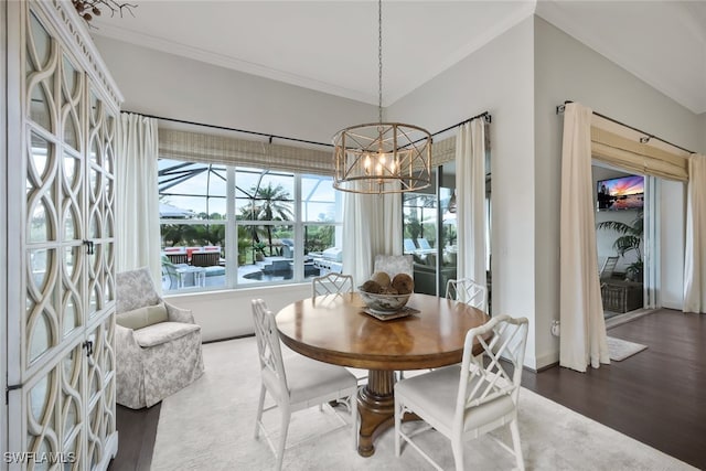 dining space featuring an inviting chandelier, dark wood-type flooring, and ornamental molding