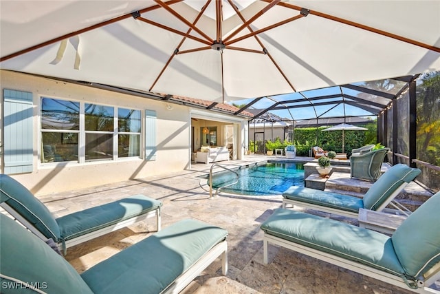 view of swimming pool featuring glass enclosure and a patio area